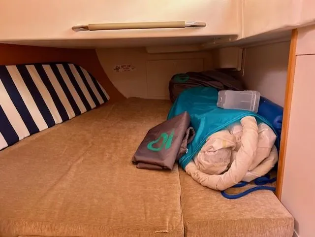 Slide: The Image of Cozy cabin interior of 2007 Hanse 400 sailboat with striped cushion and bedding. - 17