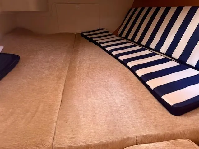 Slide: The Image of Interior cabin of 2007 Hanse 400 yacht with striped cushions and beige bedding. - 18