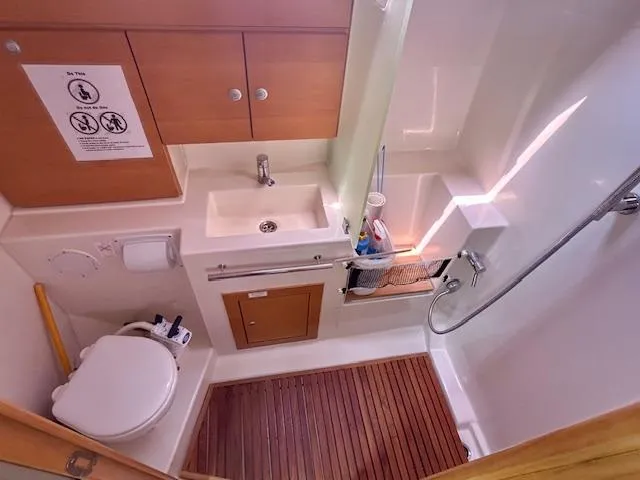 Slide: The Image of Compact bathroom in a 2007 Hanse 400 yacht with wooden flooring and modern fixtures. - 19