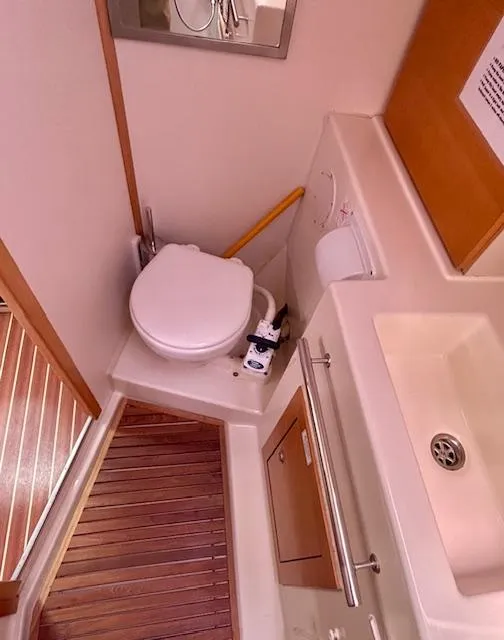 Slide: The Image of Hanse 400 2007 yacht bathroom with toilet, sink, and wooden flooring. - 20