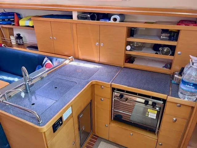 Slide: The Image of Interior of 2007 Hanse 400 yacht kitchen with wooden cabinets and modern appliances. - 24