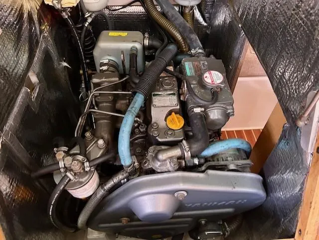 Slide: The Image of Engine compartment of a 2007 Hanse 400 sailboat, showcasing mechanical components and wiring. - 27