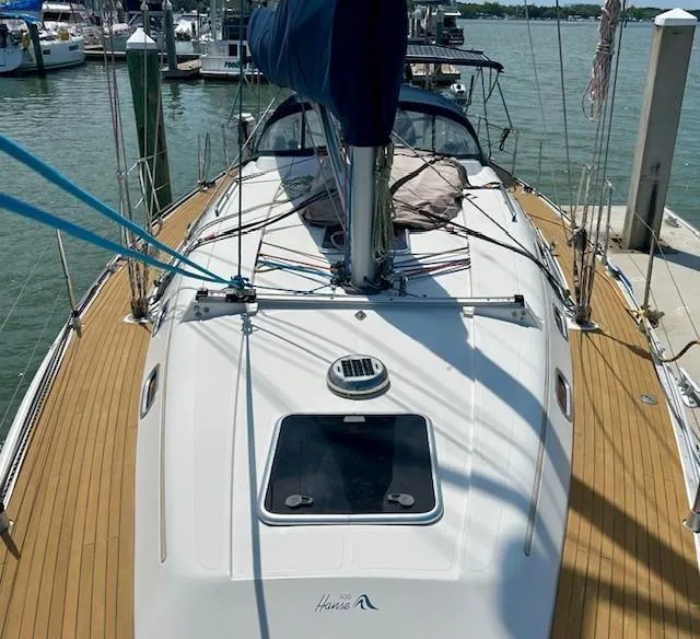 Slide: The Image of Sailboat docked at marina, 2007 Hanse 400 model, wooden deck, clear sky. - 6