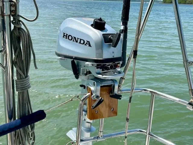 Slide: The Image of Outboard motor on a 2007 Hanse 400 sailboat, mounted on a railing over water. - 9
