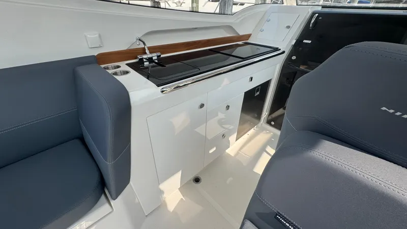 Slide: The Image of 2024 Nimbus W9 boat interior with sleek kitchen and seating area. - 10