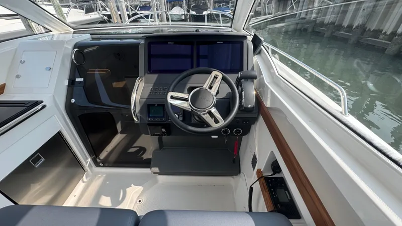 Slide: The Image of 2024 Nimbus W9 boat cockpit with modern steering and navigation screens. - 11