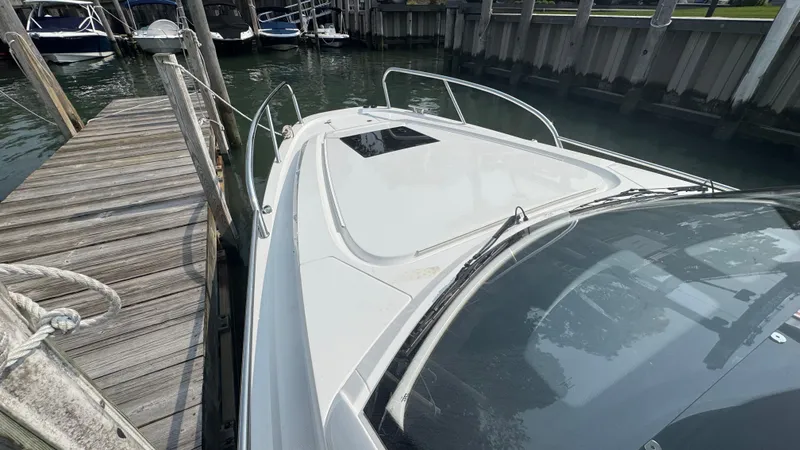 Slide: The Image of 2024 Nimbus W9 boat docked at a wooden pier, showcasing sleek design and modern features. - 18