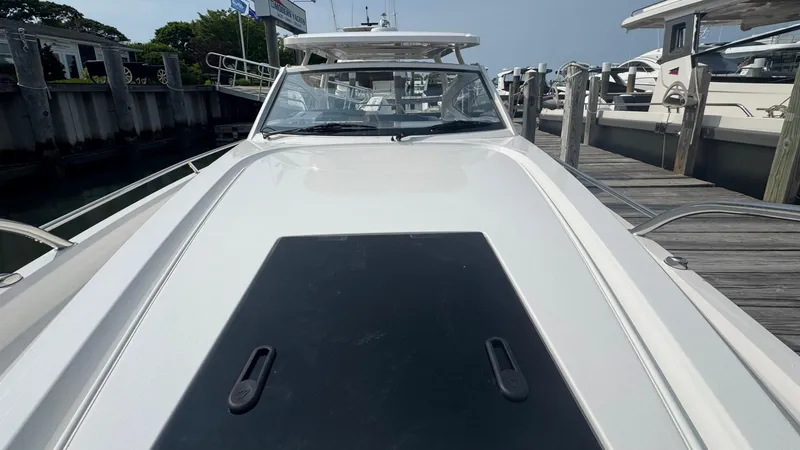 Slide: The Image of 2024 Nimbus W9 boat docked at a marina, showcasing sleek design and modern features. - 19