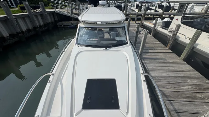 Slide: The Image of 2024 Nimbus W9 boat docked at a marina, showcasing sleek design and modern features. - 21