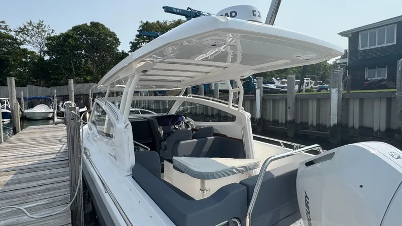 Slide: The Image of 2024 Nimbus W9 boat docked, featuring sleek design and spacious seating area. - 4