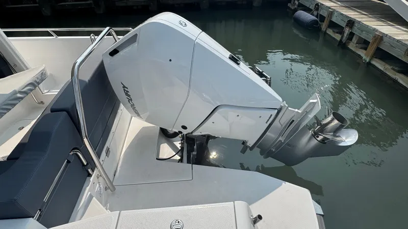 Slide: The Image of 2024 Nimbus W9 boat with modern outboard motor docked by the water. - 5