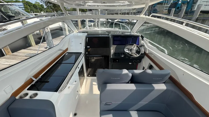 Slide: The Image of 2024 Nimbus W9 boat interior with modern helm, seating, and sleek design. - 8