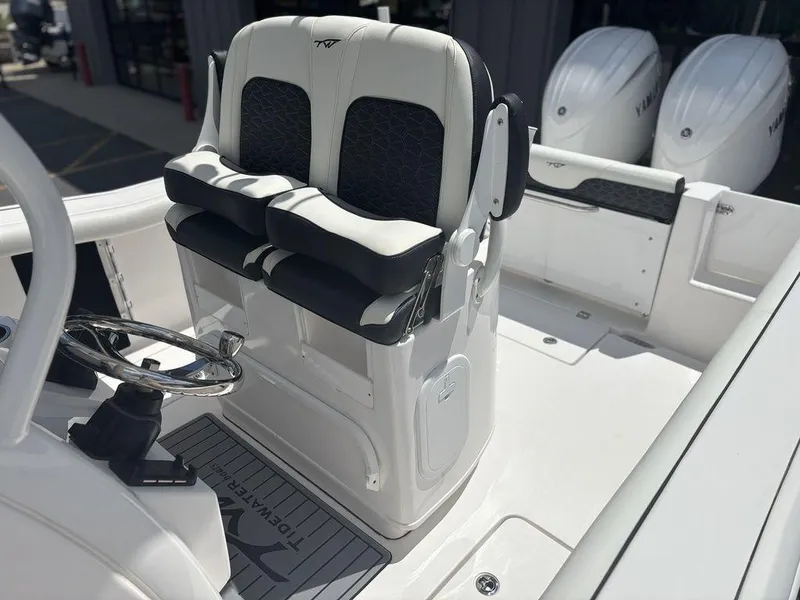 Slide: The Image of 2024 Tidewater 256 CC Adventure boat helm with dual seating and steering wheel. - 11