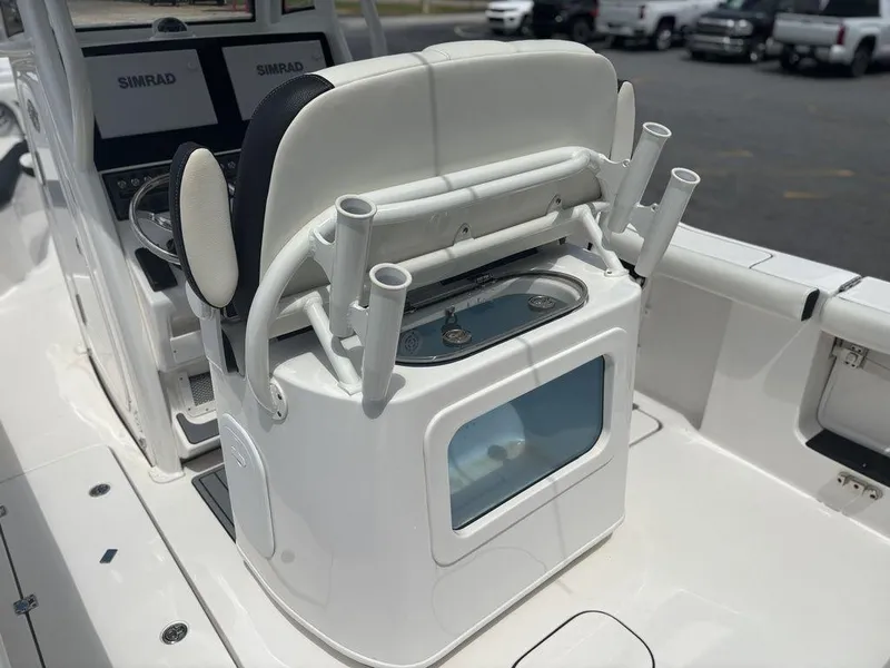 Slide: The Image of 2024 Tidewater 256 CC Adventure boat interior with rod holders and livewell. - 12