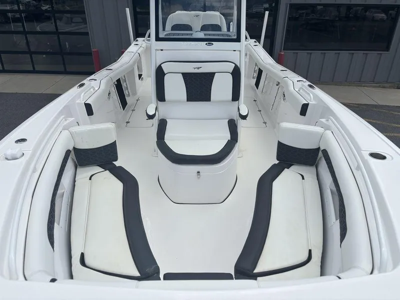 Slide: The Image of 2024 Tidewater 256 CC Adventure boat interior with sleek white and black seating. - 13