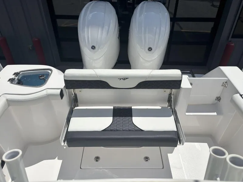 Slide: The Image of 2024 Tidewater 256 CC Adventure boat with dual engines and seating area. - 2