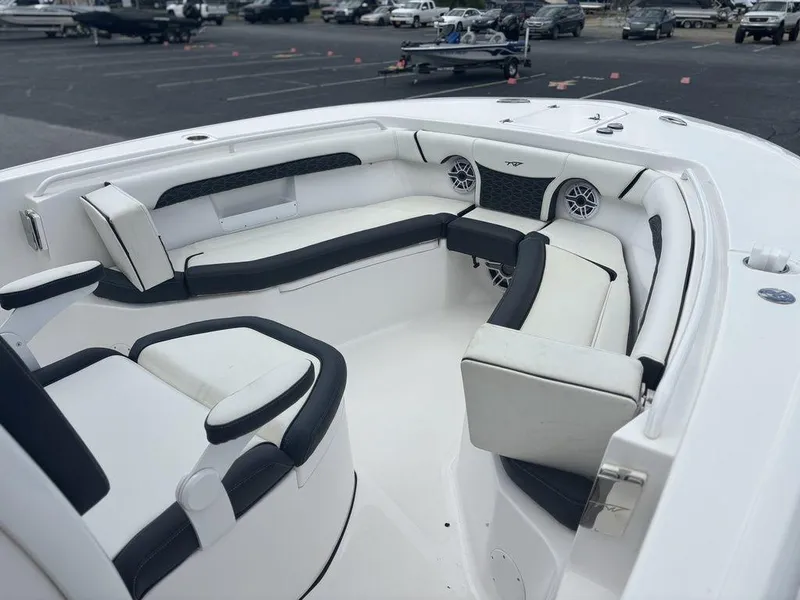 Slide: The Image of 2024 Tidewater 256 CC Adventure boat interior with white and black seating. - 7