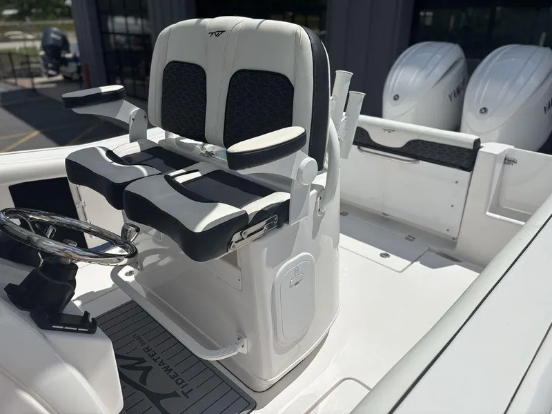 Slide: The Image of 2024 Tidewater 256 CC Adventure boat with dual seats and steering wheel. - 8