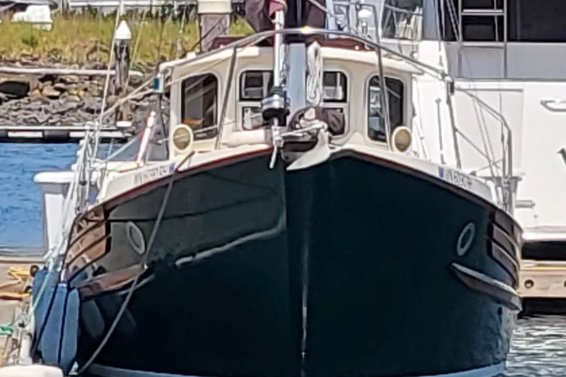 Slide: The Image of 1978 Fisher 25 boat docked at a marina, front view. - 2