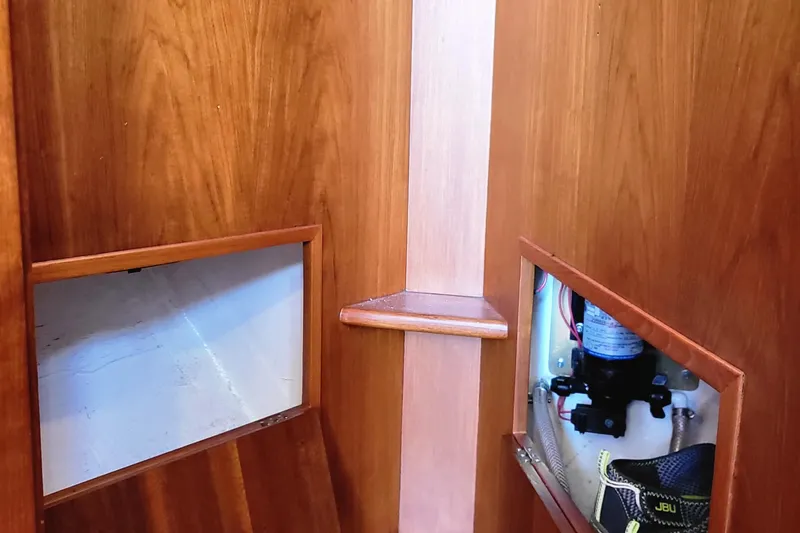 Slide: The Image of Interior of a 1978 Fisher 25 boat with wooden paneling and storage compartments. - 23