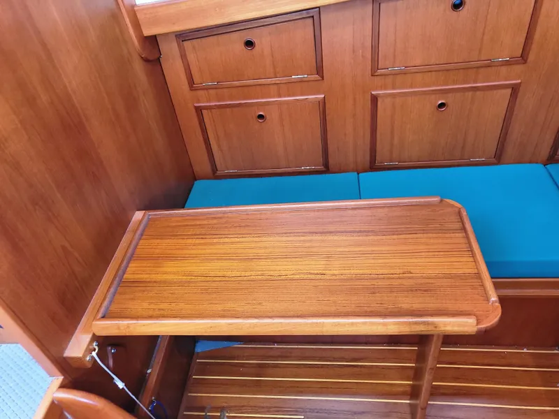 Slide: The Image of 1978 Fisher 25 interior with wooden table and blue cushions. - 27