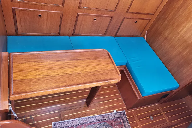 Slide: The Image of 1978 Fisher 25 interior with wooden table, blue cushions, and paneled walls. - 28