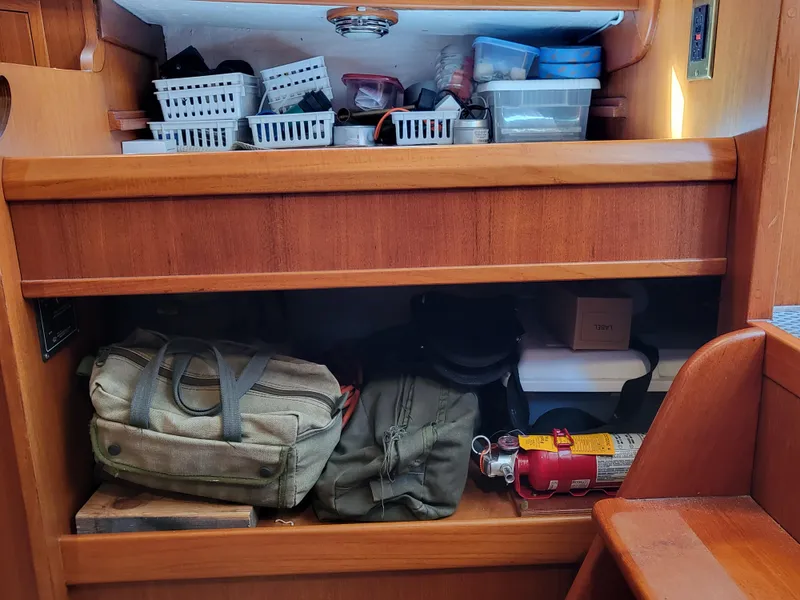 Slide: The Image of Storage area in a 1978 Fisher 25 boat with bags and safety equipment. - 29