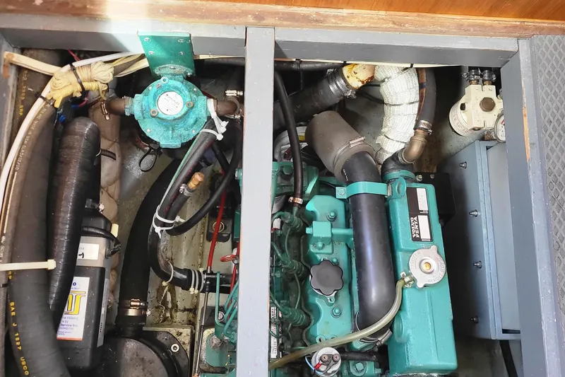 Slide: The Image of Engine compartment of a 1978 Fisher 25 boat, showcasing mechanical components and piping. - 30