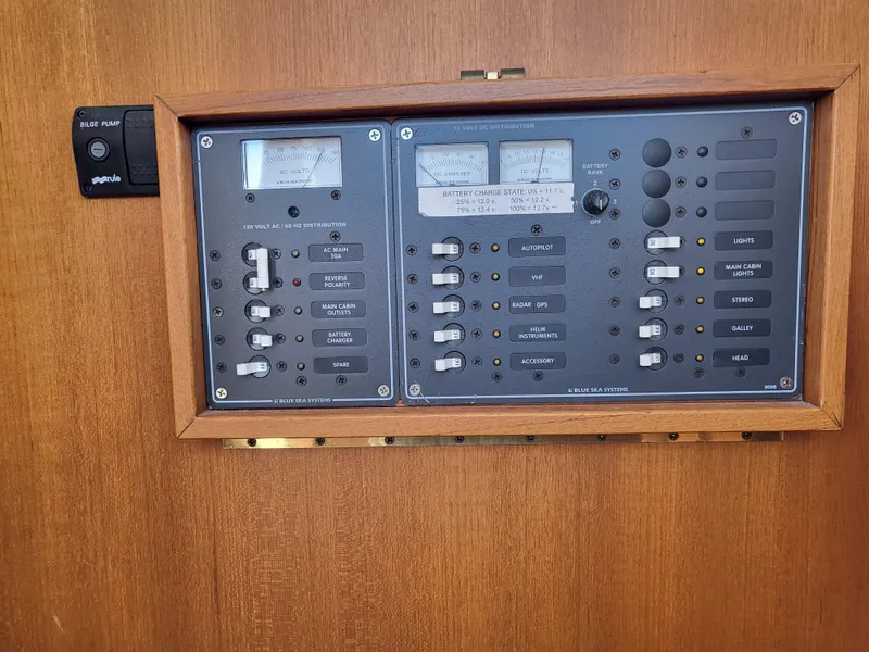 Slide: The Image of Electrical control panel on a 1978 Fisher 25 boat, featuring switches and gauges. - 32