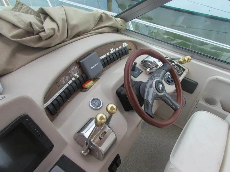 Slide: The Image of 2001 Sea Ray 340 Sundancer helm with steering wheel and controls. - 11