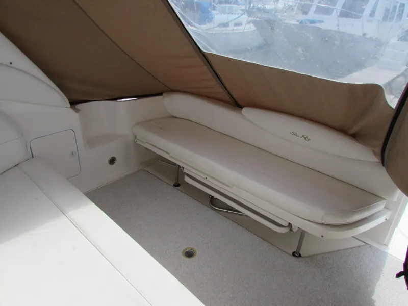 Slide: The Image of 2001 Sea Ray 340 Sundancer interior with white seating and beige canopy. - 13