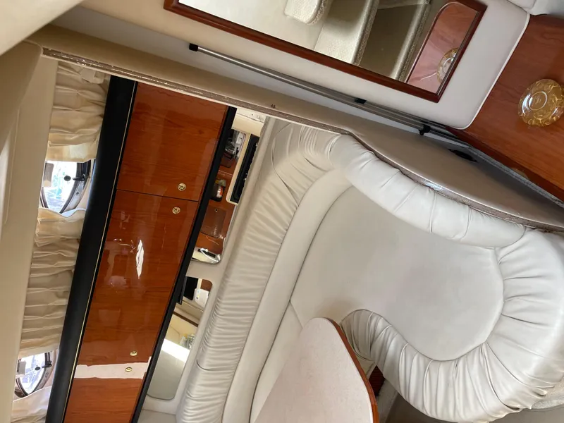 Slide: The Image of Interior of 2001 Sea Ray 340 Sundancer yacht with white leather seating and wood cabinetry. - 14