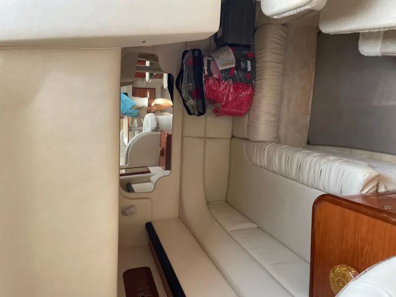 Slide: The Image of Interior of 2001 Sea Ray 340 Sundancer with white seating and wooden accents. - 15