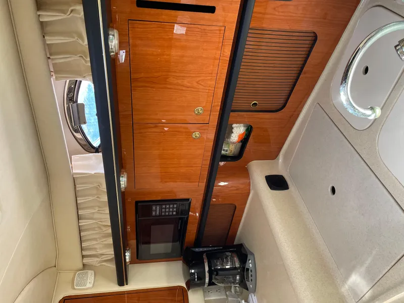 Slide: The Image of Interior of 2001 Sea Ray 340 Sundancer with wood cabinetry and kitchen amenities. - 3