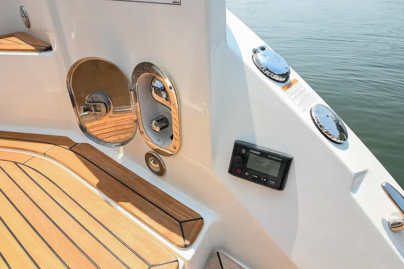 Slide: The Image of 2020 Sea Ray Sundancer 320 Coupe deck with teak flooring and control panel. - 12