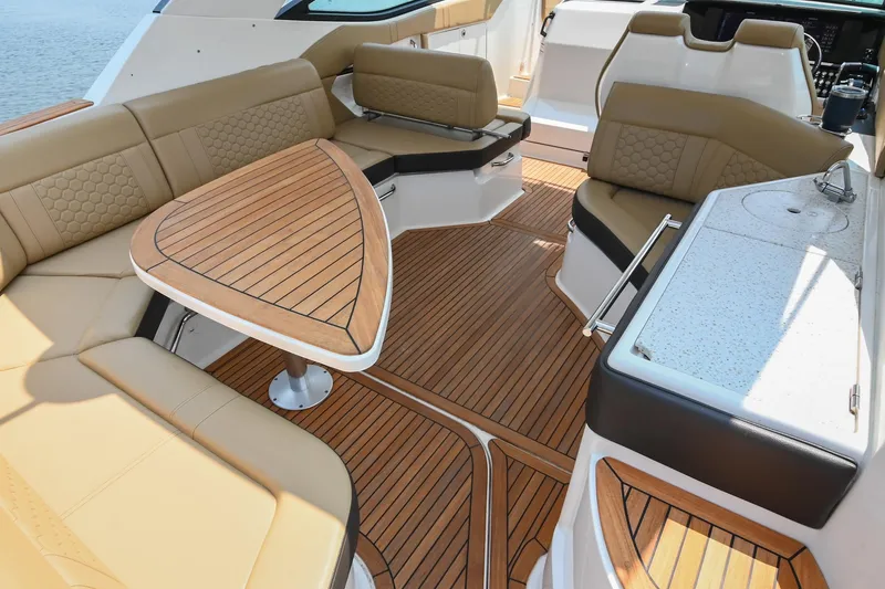 Slide: The Image of 2020 Sea Ray Sundancer 320 Coupe interior with elegant seating and wooden table. - 14