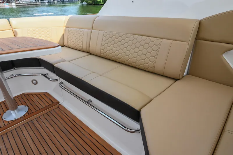 Slide: The Image of Luxurious seating on 2020 Sea Ray Sundancer 320 Coupe with elegant wood flooring. - 19