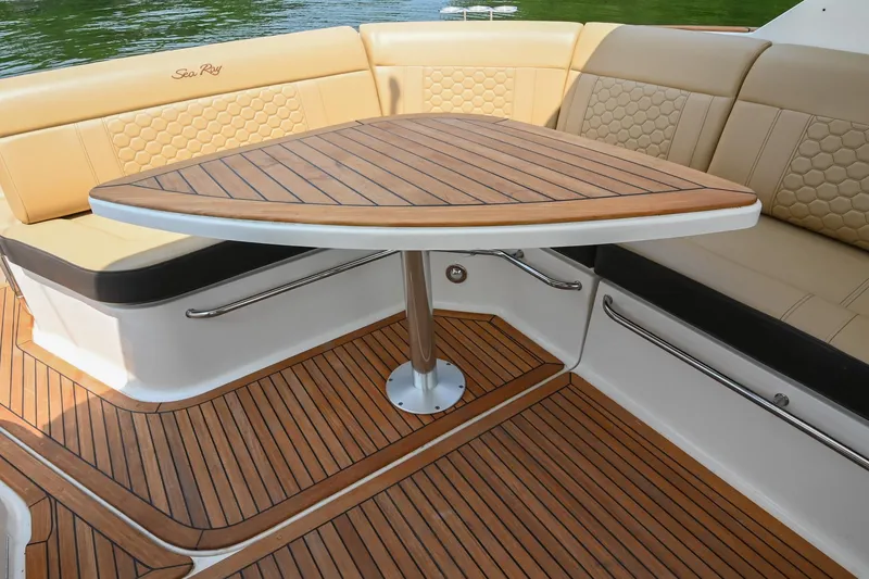 Slide: The Image of Luxurious seating area on 2020 Sea Ray Sundancer 320 Coupe with wooden table. - 21