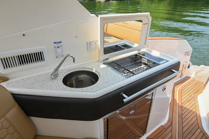 Slide: The Image of Outdoor kitchenette on 2020 Sea Ray Sundancer 320 Coupe with sink and grill. - 25