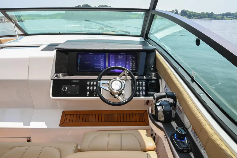 Slide: The Image of 2020 Sea Ray Sundancer 320 Coupe helm with modern controls and navigation screens. - 28