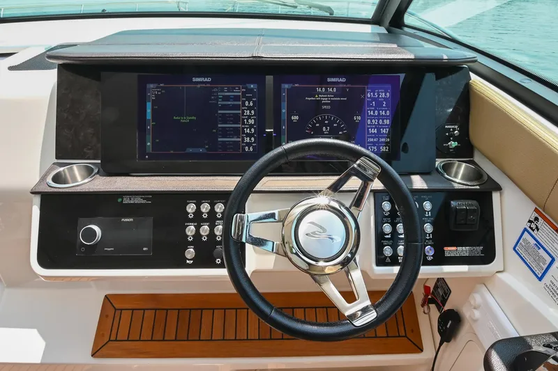 Slide: The Image of 2020 Sea Ray Sundancer 320 Coupe helm with advanced navigation displays and controls. - 30