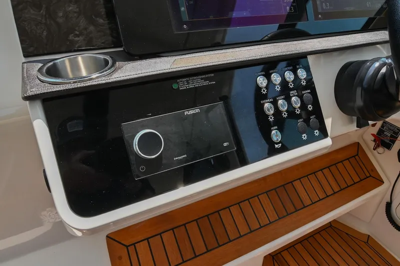 Slide: The Image of 2020 Sea Ray Sundancer 320 Coupe dashboard with control panel and cup holder. - 31