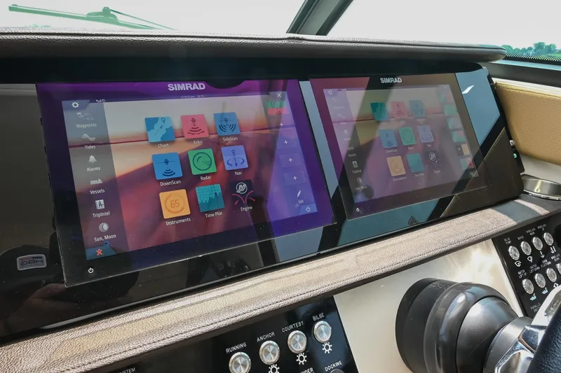 Slide: The Image of Dashboard of 2020 Sea Ray Sundancer 320 Coupe with dual Simrad displays. - 33