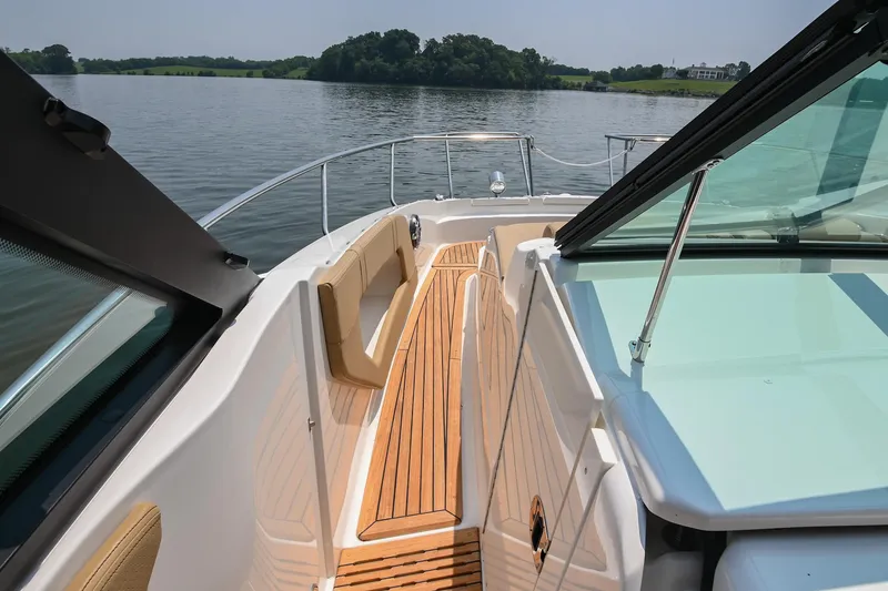 Slide: The Image of 2020 Sea Ray Sundancer 320 Coupe, teak deck, cruising on a serene lake. - 38