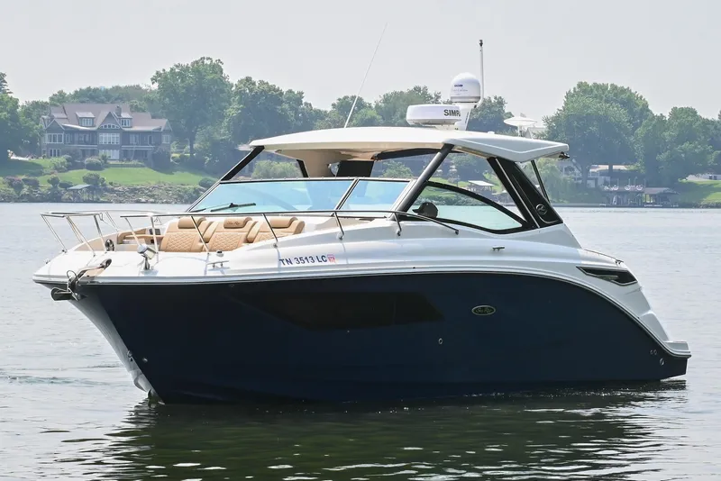 Slide: The Image of 2020 Sea Ray Sundancer 320 Coupe on a serene lake with lush greenery. - 4