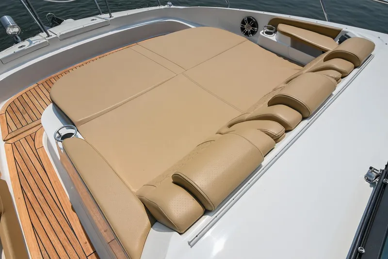 Slide: The Image of Luxurious sunbed on 2020 Sea Ray Sundancer 320 Coupe yacht, featuring tan upholstery and teak decking. - 42