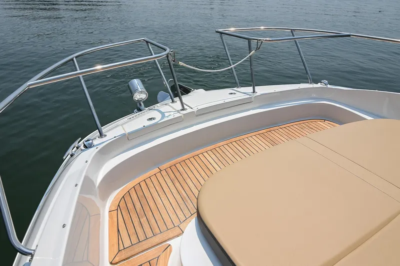 Slide: The Image of 2020 Sea Ray Sundancer 320 Coupe deck with teak flooring and cushioned seating. - 43