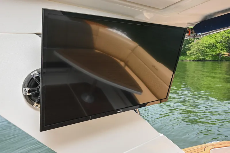 Slide: The Image of Flat-screen TV on 2020 Sea Ray Sundancer 320 Coupe yacht, near water. - 46