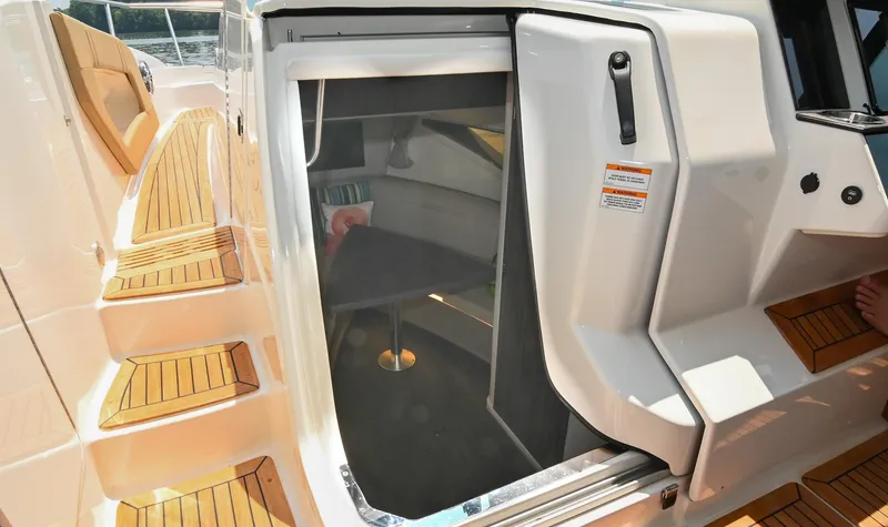 Slide: The Image of 2020 Sea Ray Sundancer 320 Coupe cabin entrance with teak steps and modern interior. - 47