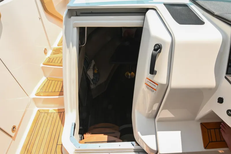 Slide: The Image of 2020 Sea Ray Sundancer 320 Coupe cabin entrance with teak steps and open door. - 49